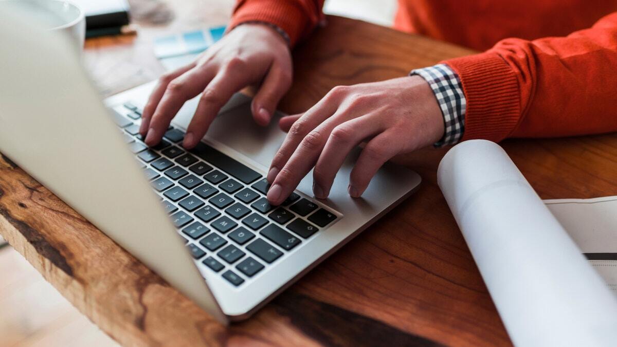 Image of person typing on laptop